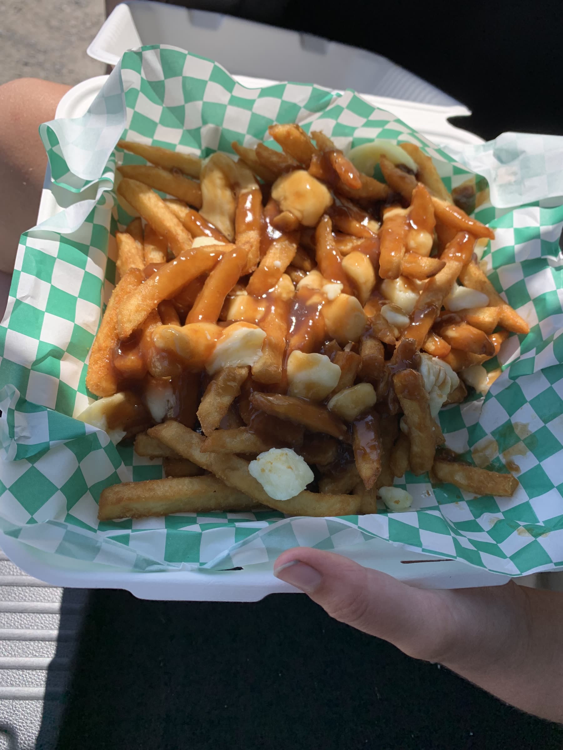 A takeout container of poutine — fries, cheese curds and gravy — from Tide's In at Kingsport Beach