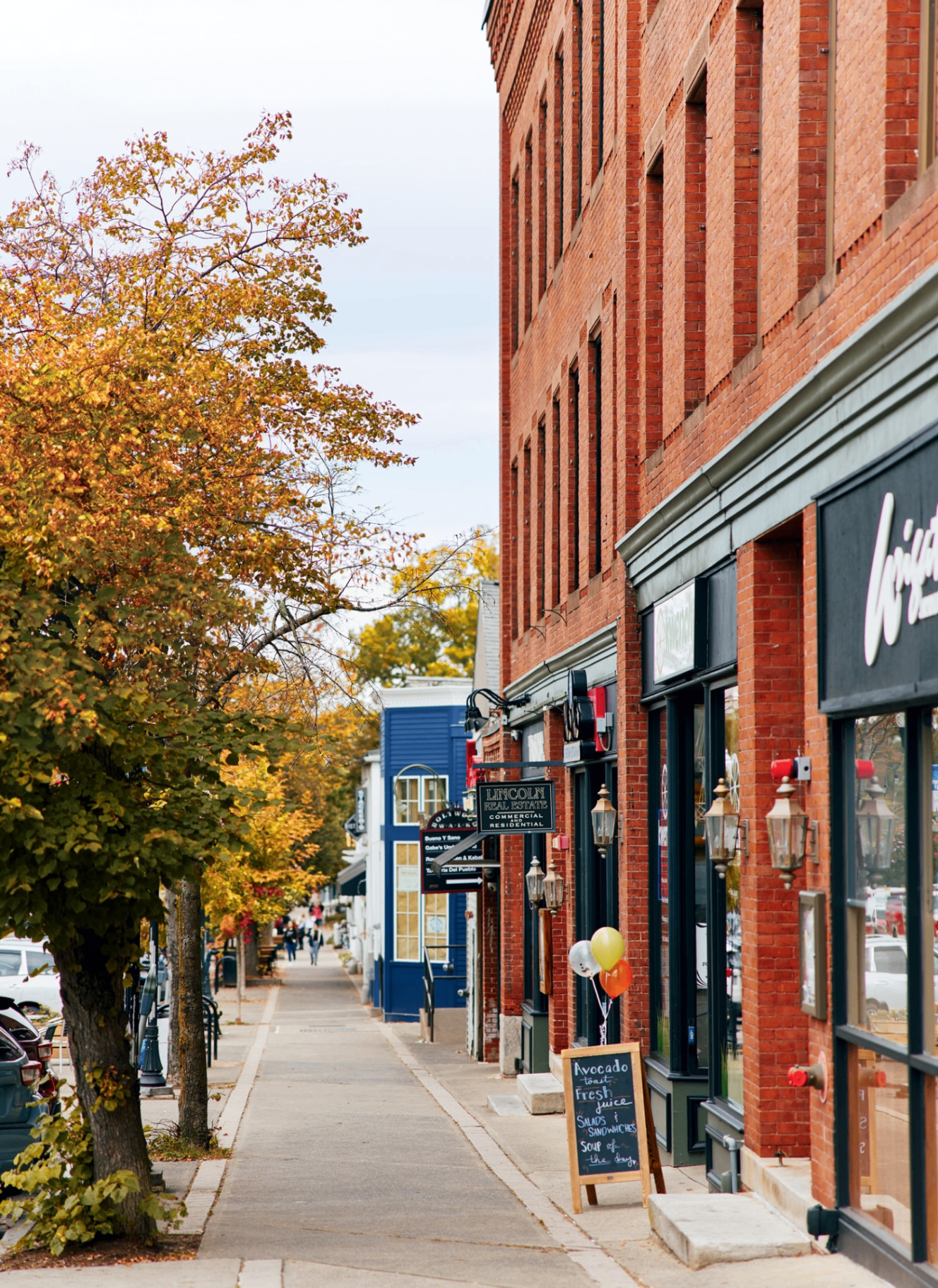 Brick storefronts and autumn trees along a small-town main street near Joggins