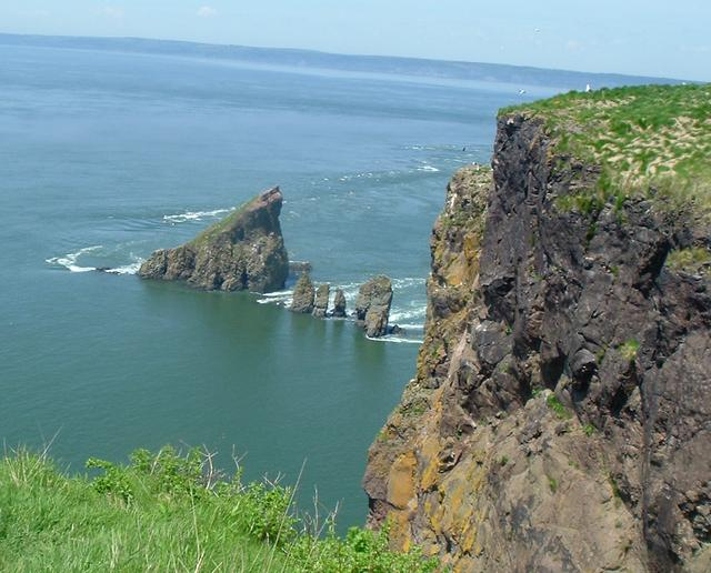 Sea stacks below the cliffs at Cape Split with turquoise water