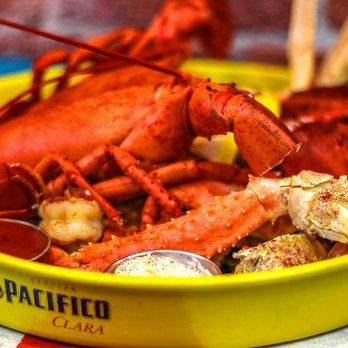 Lobster and crab legs served on a bright yellow platter